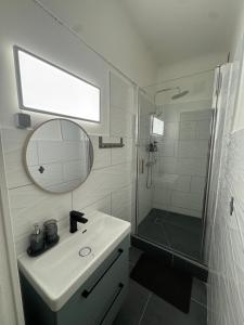 a bathroom with a sink and a shower and a mirror at La Parenthèse Cassidaine in Cassis +12 photos