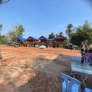 a group of buildings with blue roofs and a playground at Luna bungalow chi phat in Chi Phat +13 photos