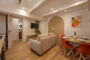 a living room with a table and a couch at Chez Mel & Romain in Montauban