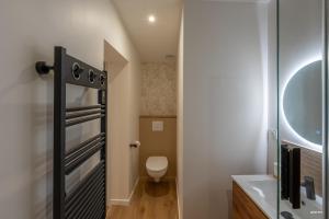a small bathroom with a toilet and a sink at Chez Mel & Romain in Montauban +28 photos