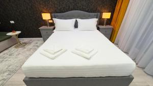 En eller flere senge i et værelse på Relax Stay Brasov