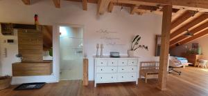 a room with a white dresser and a bedroom at Isartraum Brauneck in Gaißach +17 photos