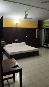 瓦尔卡拉VALLABHAN INTERNATIONAL resort的一间卧室，里面有一张大床和一张桌子。