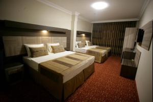 Cama o camas de una habitación en Hotel Guven