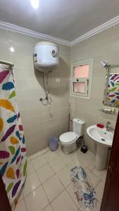 a bathroom with a toilet and a sink at 3 Bedroom Chalet at Dimora Village North Coast Egy - الساحل الشمالي - قرية ديمورا - شاليه 3 غرف in Dawwār Muḩammad Abū Shunaynah