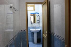 a bathroom with a sink and a mirror at Qala Masalli Resort in Masallı