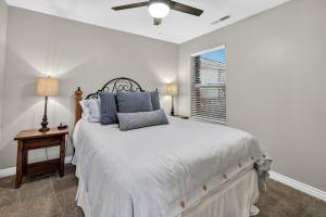 a white bedroom with a bed and a window at Cozy Desert Retreat Near Zion - Patio Dininggrill in La Verkin