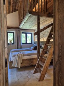 a bedroom with a bunk bed in a wooden house at Chalet Hideaway Alpi mit Sauna und Bergblick in Grainau