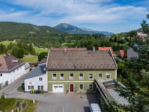 an aerial view of a large yellow building with a red door at Steinmetz-Haus in Mariazell