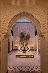 an archway with a tree in the middle of a building at Riad Kheirredine in Marrakesh