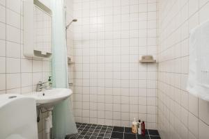 a white bathroom with a sink and a mirror at Newly furnished apartment in Hede near Avesta in Horndal +17 photos