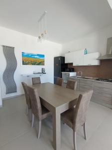 a kitchen with a wooden table and chairs at Villa Nunzia in Ostuni