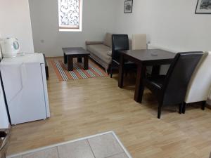 a living room with a table and chairs and a couch at Vlašić Vacation apartment in Vlasic