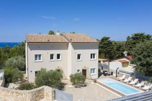 a villa with a swimming pool and a house at Villa Nocciola with Sea View, Private Pool and Sauna in Premantura