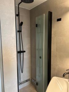 a shower with a glass door in a bathroom at The Green House in Norrtälje