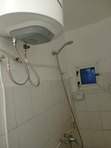a shower in a bathroom with a blue window at Transit in Nouakchott +57 photos