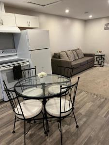 a living room with a table and chairs and a couch at Cozy Private Suite with Parking near restaurants in Regina +21 photos