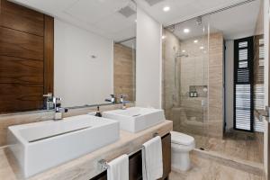 a bathroom with a sink and a toilet and a mirror at 2 BR Apartment in Marina Condo in Cancún +11 photos