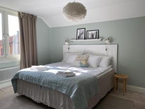 a bedroom with a bed with two towels on it at The Green House in Norrtälje +10 photos