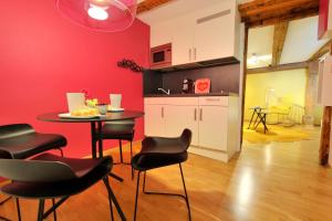 a kitchen with a table and chairs in a room at Apartments Constance in Konstanz