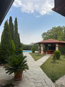 a patio with a gazebo and a pool at Vila Laci private poll billiard garden in Skopje