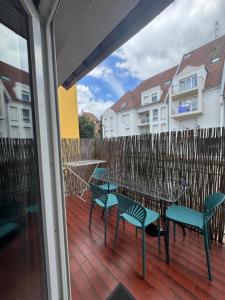 a patio with tables and chairs and a fence at LA TERRASSE SELESTADIENNE in Sélestat