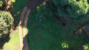 an overhead view of a green field with a road at Minicasa Rural Maria Preta in Puerto Iguazú +3 photos