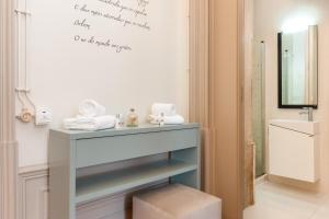 a bathroom with a vanity with a sink and a mirror at Serenata Hotel & Hostel Coimbra in Coimbra +73 photos