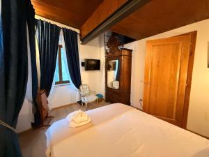 a bedroom with a bed and a chair and a window at Visione Piazzetta Alferi 2 in LʼAquila +10 photos