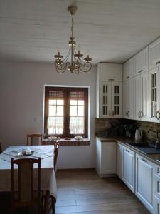 a kitchen with a table and a chandelier at Słoneczne apartamenty Zator blisko Energylandii in Zator