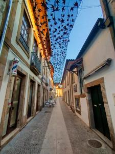 an alley with a bunch of pigeons hanging from a ceiling at Douro & Sabor Escape in Torre de Moncorvo