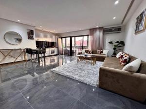 a large living room with a couch and a table at Chic Duplex Central 3 Suites et Wi-Fi in Marrakesh
