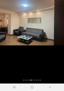 a living room with a couch and a coffee table at Квартира in Aghk'ilisa