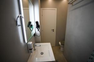 a bathroom with a sink and a mirror and a toilet at Hera Elegant Suite by Zeus Suites in Athens