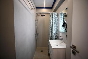 a bathroom with a sink and a mirror at Hera Elegant Suite by Zeus Suites in Athens