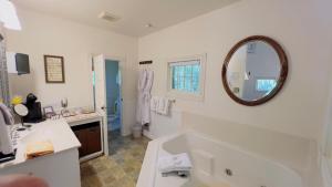 a bathroom with a tub and a sink and a mirror at Rock Cottage Gardens B&B in Eureka Springs +44 photos