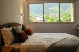 Ένα ή περισσότερα κρεβάτια σε δωμάτιο στο Nomad Suites Altamira