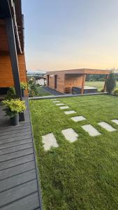 a yard with rocks in the grass next to a house at Chalet Sijkovsky in Stará Lesná