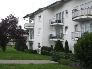a white building with balconies on the side of it at Ferienwohnungen an der Therme in Bad Rodach