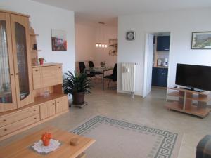 a large living room with a television and a table at Ferienwohnungen an der Therme in Bad Rodach