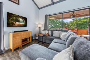 a living room with a couch and a tv at Kailua Bay Resort#2-306 in Kailua-Kona