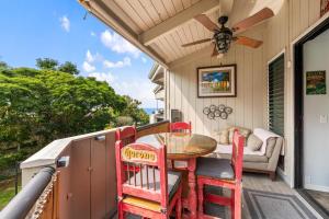 a porch with a table and chairs and a ceiling fan at Kailua Bay Resort#2-306 in Kailua-Kona