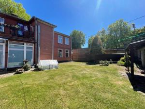 a backyard of a house with a large yard at ''Rozā namiņš'' in Ventspils