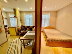 a small room with a bed and a table at ''Rozā namiņš'' in Ventspils