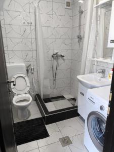 a bathroom with a shower with a toilet and a sink at Planinska Kuca "KABLAR" Jahorina in Ćetinište
