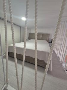 a bedroom with a bed in a rope swing at Lux Studio Porto in Tivat
