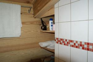 a small bathroom with wood paneling and a towel at La Palombière in Saint-Symphorien +26 photos