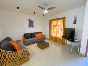 a living room with a couch and a piano at Casa Condominio Barra de Juquehy in Juquei
