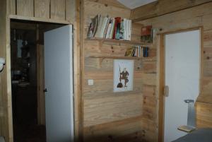 a room with a wall of wood paneling at La Palombière in Saint-Symphorien