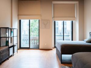 a bedroom with a bed and sliding glass doors at 104 Location 2Bdrm 2bath AC apt Fits 8 Rooftop in Mexico City